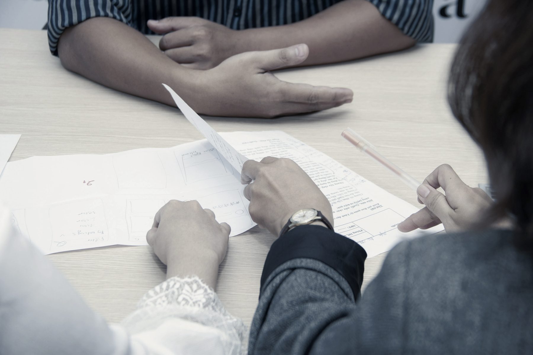 Two people reviewing documents at a table